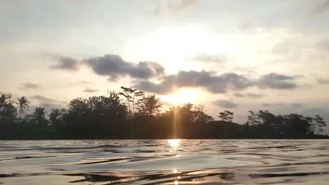 Sunset on the bank of a river. Video stock 177201631