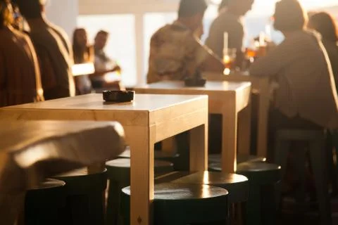 Sunset bar by the beach - focus on table Stock Photos