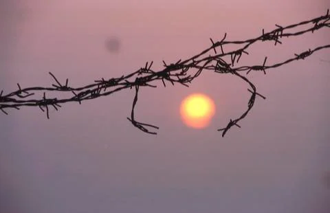 Sunset from barbed wire killing fields camboya Stock Photos