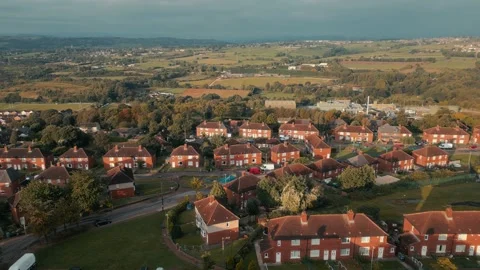 Sunset bathes red-tiled homes in golden glow Vidéo 343559648