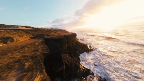 Sunset bathes rugged cliffs in golden light Stock Footage 340914542