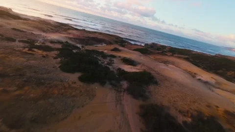 Sunset bathes rugged cliffs in warm, golden light Stock Footage 340914821
