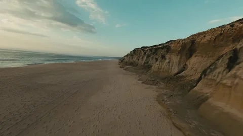 Sunset bathes sandy beach with soft waves Stock Footage 340227348