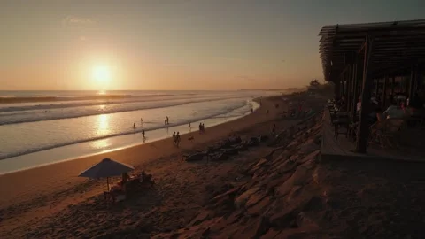 Sunset Batu Belig Beach Bali Tourists, Ocean Waves, Relaxing Bean Bags Stock Footage 345043964