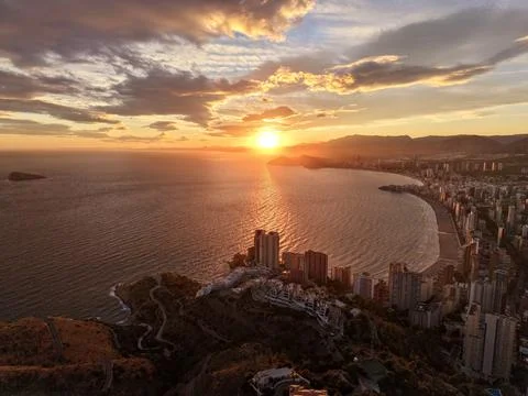 Sunset bay tranquility, dusk illuminates coastal landscape featuring tranquil Stock Photos