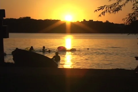 Sunset beach activity- people silhouettes crossing Stock Footage 126293754