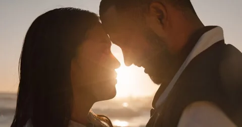 Sunset, beach and couple with face for love by ocean for commitment, bonding and 動画素材 250329321