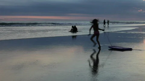 Sunset, beach and playing children in Bali Stockbeeldmateriaal 461266