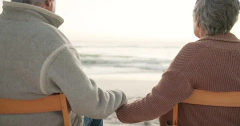 Sunset, beach and senior couple on chair by ocean for commitment, bonding and 動画素材 244836330