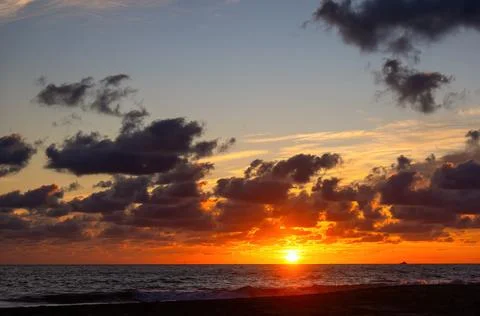 Sunset on the beach with beautiful clouds Stock Photos