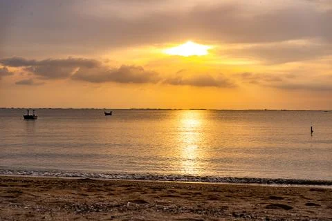 Sunset on  the beach begin to go doown Stock Photos