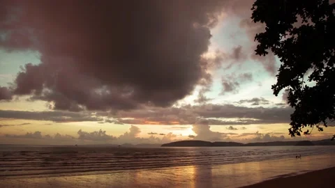 Sunset on the beach with big dark cloudy on sky Stock Footage 153507329