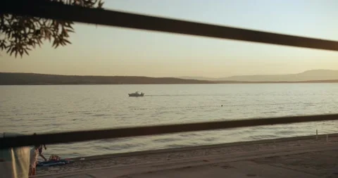 Sunset beach boat passing by 動画素材 141740959