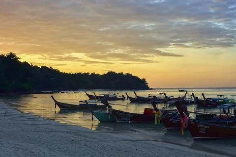 Sunset on the beach with boats Stock Photos