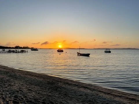 Sunset on the beach with boats Stock Photos