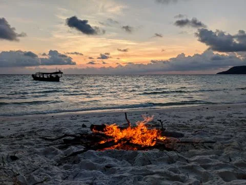 Sunset beach with bonfire Stock Photos