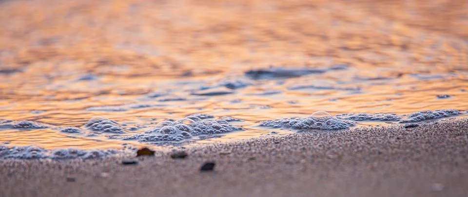 Sunset at the beach with bubbles 스톡 사진