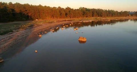 Sunset beach, C4K aerial view of a rocky coast, on a warm summer day, on a su Stock Footage 91841246