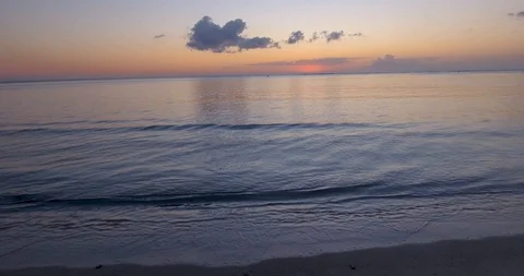 Sunset on beach, calm ocean, crashing waves Stock Footage 95325860