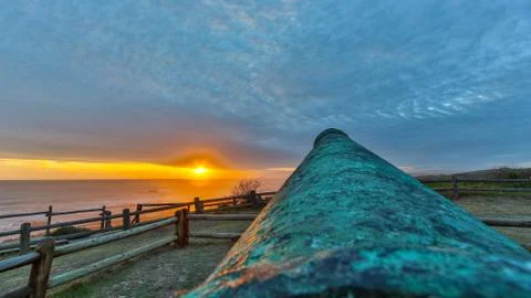 Sunset at the beach with a cannon Stock Photos