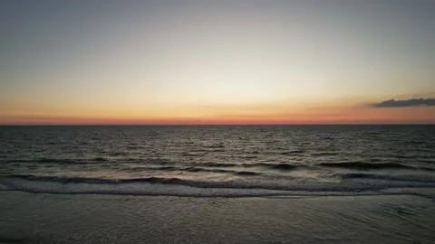 Sunset on the beach in the Caribbean with gentle waves in UHD 4K Stock Footage 217390032