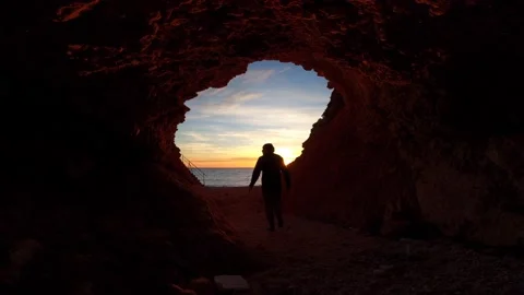Sunset Beach Cave Man Walk Stock Footage 130536084