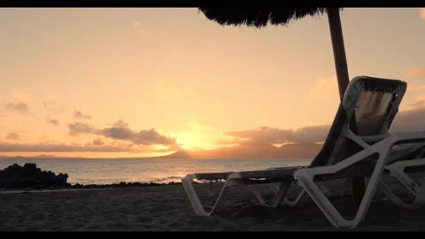 Sunset beach chairs evening Video stock 274034748
