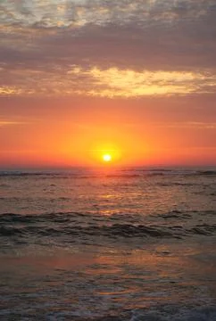 Sunset on the beach with clouds texture in the sky Stock Photos