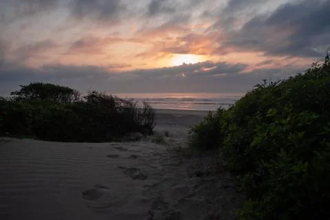Sunset on the beach colorful clouds Stock Photos