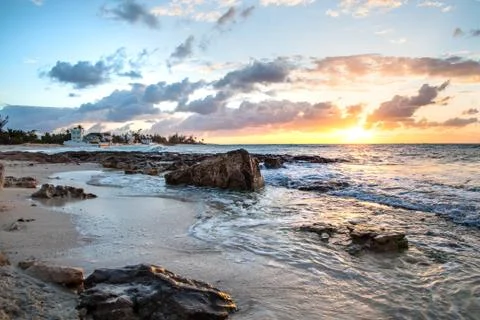Sunset beach with dramatic rocks in low tide on the Bahama Island Stock Photos