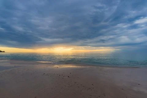 Sunset on a beach with dramatic sky nature background Stock Photos