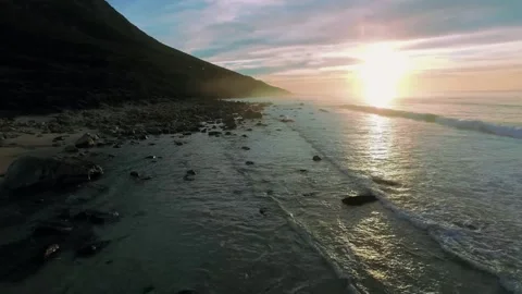 Sunset beach drone, golden hour coast, cinematic shoreline view Stock Footage 309535384
