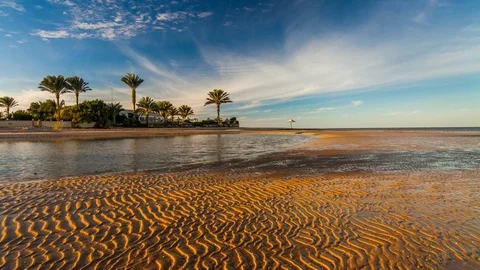 Sunset on the beach in Egypt. Movement of clouds over a beach with palm trees Stock Footage 71089113