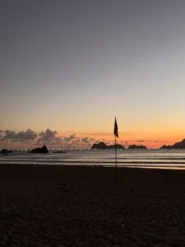 Sunset Beach with Flagpole and Distant Islands. Pulau Merah Beach Banyuwangi Stock Photos