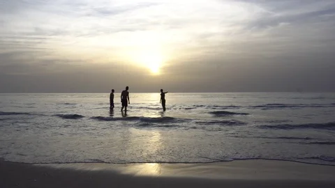 Sunset on the beach in Israel. Children in the backlight dance in the water Stock Footage 88862030
