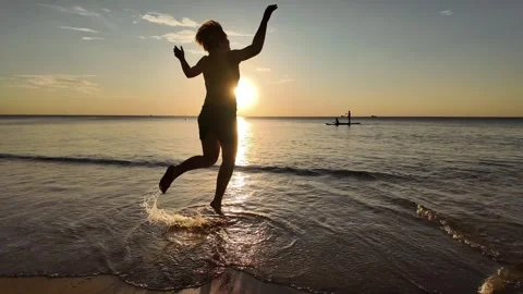 Sunset Beach Jump, Silhouette of Joy Stock Footage 259688982