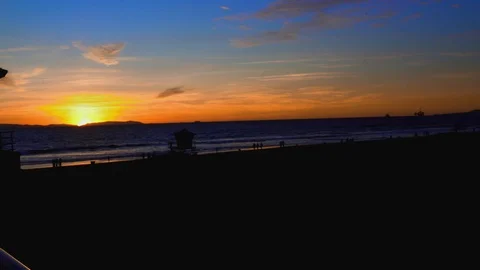 Sunset at the beach with lifeguard tower, 4K Stock Footage 101002466