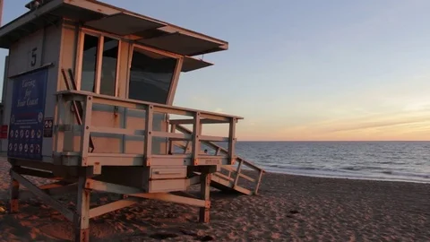 Sunset beach lifeguard tower Stock Footage 82549717