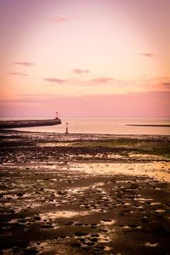 Sunset at the beach with a lighthouse, England. Stock Photos