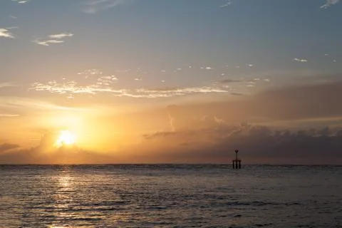 Sunset on the beach with lighthouse Stock Photos
