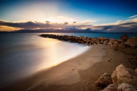 Sunset at beach with long exposure Stock Photos