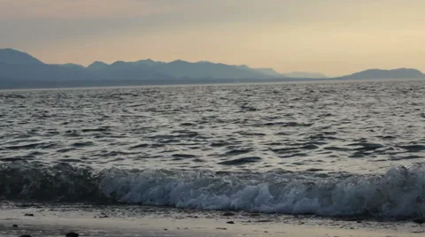 Sunset At The Beach With Mountains and Waves Stock Footage 54213780