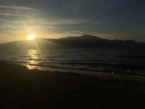 Sunset on the Beach with Mountains Stock Photos