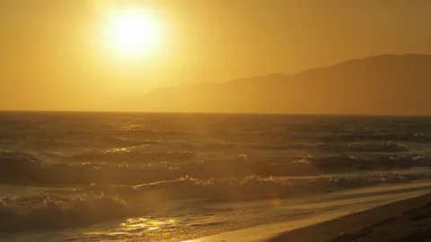 Sunset. On beach ocean water. slowmo A Stock Footage 102404019