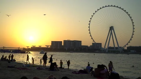 Sunset beach over Bluewaters island with modern architecture and ferris wheel Stock Footage 229532870