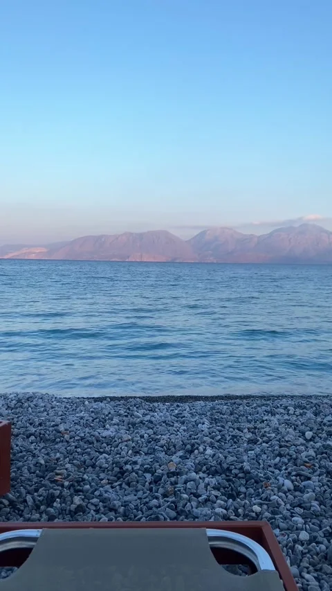 Sunset on the beach. Pebble beach. Vertical video Stock Footage 287492556