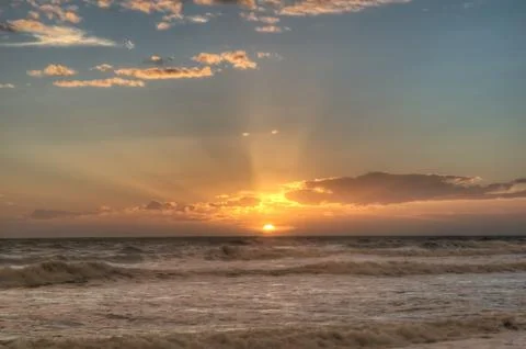 Sunset on a beach Stock Photos