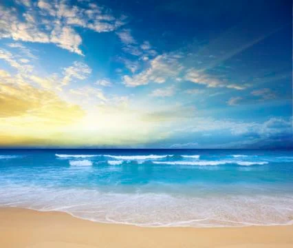 Sunset on a beach Stock Photos