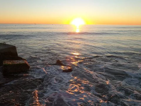 Sunset on a beach Stock Photos