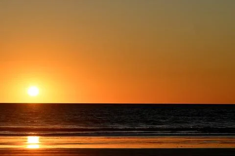 Sunset on a beach Stock Photos